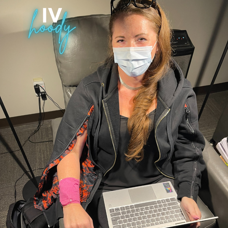 IV Hoody founder showing off the flames in the arm lining - wearing Embers in Coal IV Hoody.  She is ready to add some heat packs to get warm and cozy for her Ozone treatment.