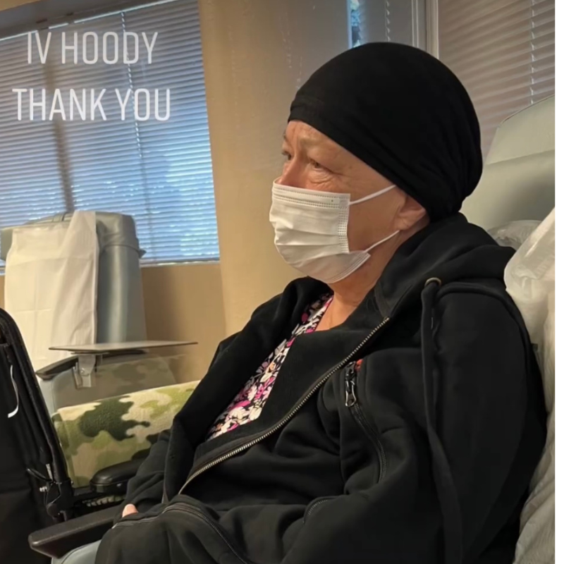 Patient staying warm in her IV Hoody, Embers in Coal, while receiving Chemotherapy.